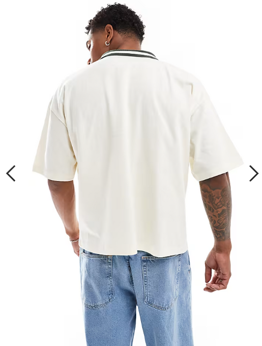 ASOS DESIGN boxy oversized polo shirt in off white with football front print