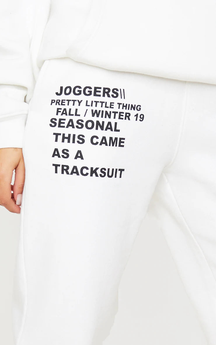 LOGO CREAM SLOGAN PRINTED JOGGERS