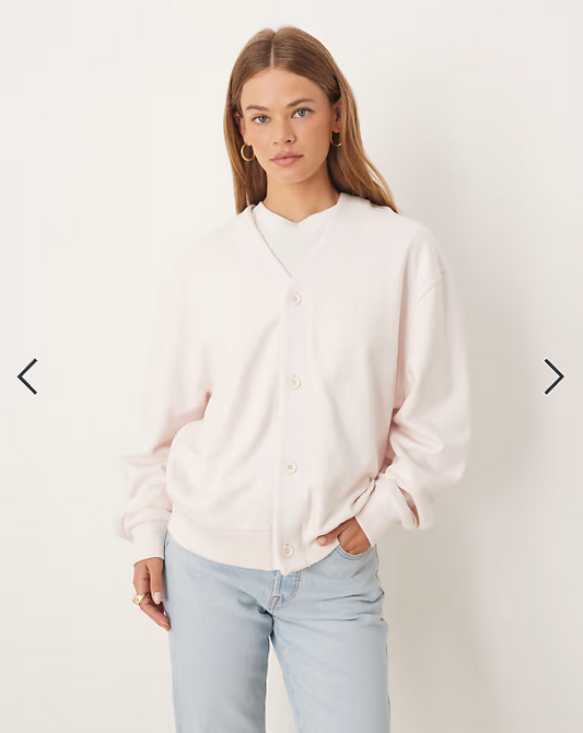 ASOS DESIGN Disney Pixar oversized cardigan with Jessie Toy Story print in pink