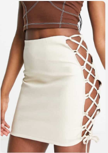 Rebellious fashion - leather look mini skirt with tie detail in ecru