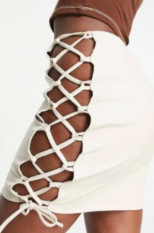 Rebellious fashion - leather look mini skirt with tie detail in ecru